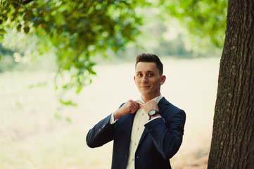 Groom portrait on a park at a wedding day