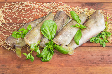 Uncooked carcasses of the notothenia fish on a wooden surface