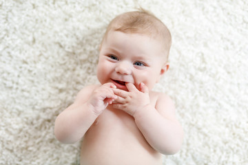 Adorable naked baby girl on white background. © Irina Schmidt