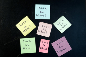 Colorful stickers on the chalk Board that says back to school
