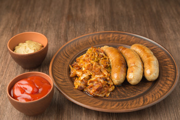 Grilled sausages with sauerkraut, mustard and tomato sauce. 