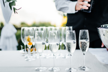 waiter and glasses of champagne on table