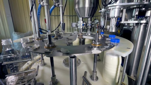 A side view on an automatic milk-bottling machine.    