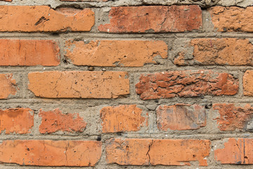 Texture of a very old cracked brick wall.