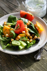Salad on plate and sauce in jar