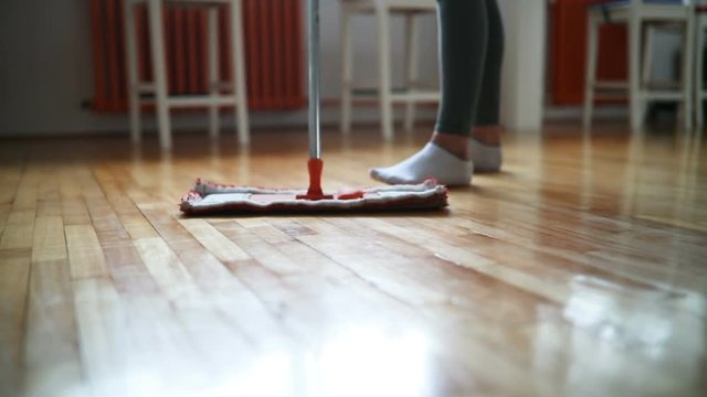 Woman using mop cleaner to do household chores faster
