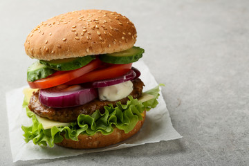 Burger with tomatoes and sauce