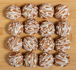 Cookies covered with frosting on a wooden stand.