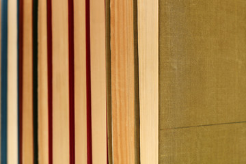 Horizontal row of old thick books close-up