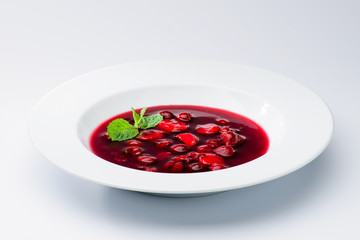 classic Italian food. Beautifully decorated plate with strawberries and raspberries in a ginger juice, dark background