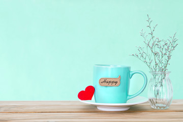 Coffee cup mug with red heart shapeand happy word tag on wooden table , Romance and love valentines day background concept