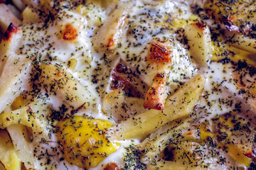 Potato dish with egg and thyme top view, baked in the oven.