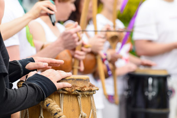 drummer with traditional Brazilian Drum and drum sticks, selective focus