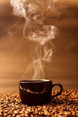 still life of warm black cup of coffee on  roasted coffee beans