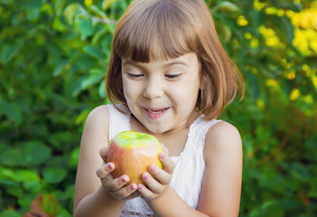 Child with an apple. Selective focus. 