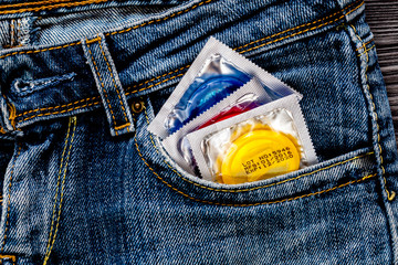 concept male contraception condom in jeans pocket