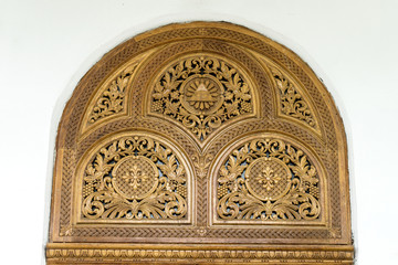 Carved wooden decorations on white wall