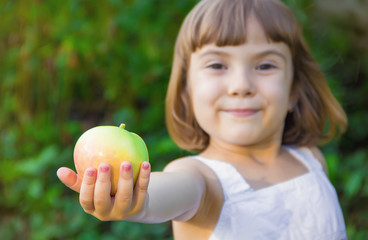 Child with an apple. Selective focus. 