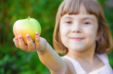 Child with an apple. Selective focus. 