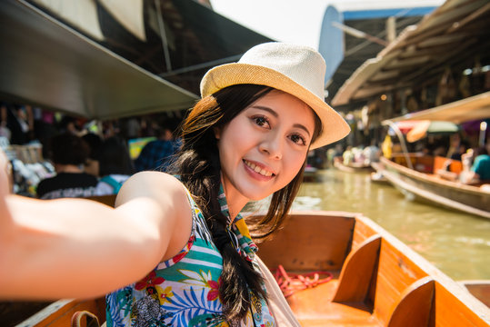 women taking selfie on floating market holiday