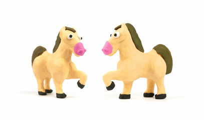 Cute horse modeling clay isolated on white background. Handmade plasticine. Close up.