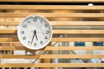 White clock on wooden wall