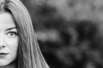 Half portrait of young scared woman looking afraid at camera