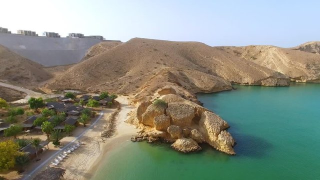 Aerial view of Muscat bay, dive resort, day trip and relaxing area, crystal clear water of Indian Ocean, beach and blue lagoon - Oman sultanate on Arabian Peninsula, 4k UHD 