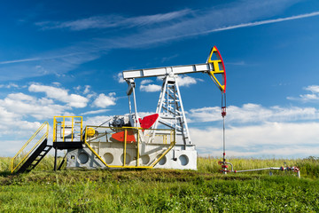 Fototapeta na wymiar Oil Pump/oil pump on a background of field and sky
