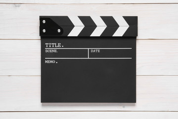 blank clapper board on top view vintage white wood table for the action scene or filming and...