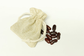 red bean or kidney bean scatter with brown sack on white background