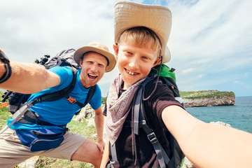 Fototapeta na wymiar Father and son take their active vacation selfie photo