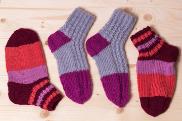 knitted socks on wooden background