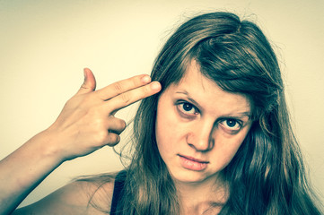 Fototapeta premium Woman committing suicide with two fingers