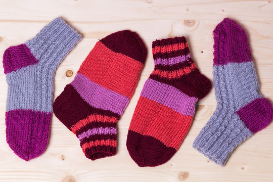 knitted socks on wooden background