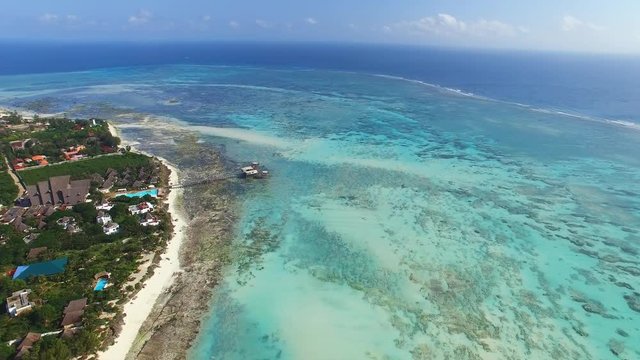 Aerial view of Nungwi village discrict, Blue Lagoon, North part of Zanzibar, White beach, Palm paradise, Tanzania from above