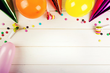 birthday party accessories with copy space on white wood background