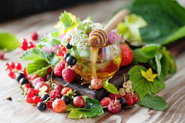 Hot herbal tea with fresh summer berries and herbs