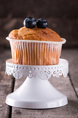 muffin with blueberries on a wooden table. fresh berries and sweet pastries on the board