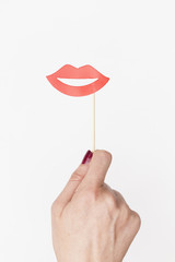 female hand holding lips photo booth prop