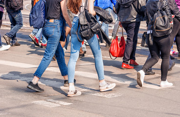 young woman feet, crossing an urban street