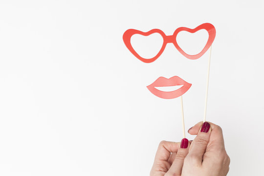 female hand holding glasses and lips photo booth prop