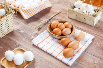 Close-up view of raw chicken eggs on wooden background