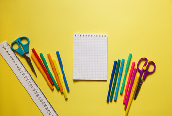 back to school styled pattern with school supplies on yellow background