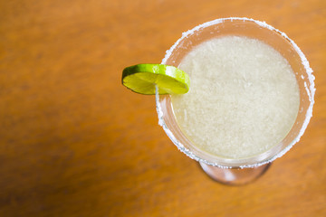 Yellow coctail with lime, margarita cocktail with salty rim