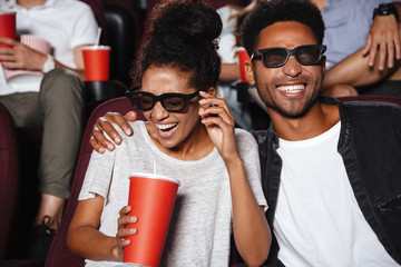 Attractive afro american couple watching 3D movie
