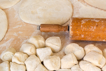 Rolled out pizza dough on floured surface.