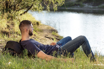 Man on hike in nature using digital tablet