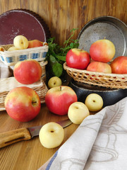 Apples and white nectarines on a wooden table and in wicker baskets
