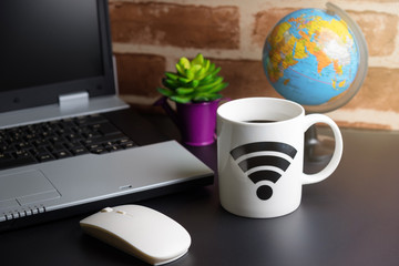Table of office stuff Business man with Laptop, Wireless mouse, Coffee Cup WIFI symbol.Concept office Business man workplace.